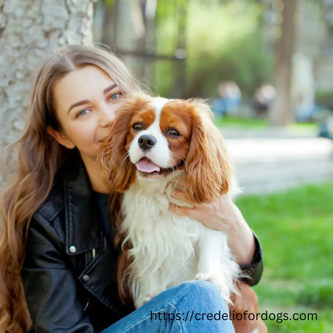 A woman holding a small dog in her arms, both looking happy and content.